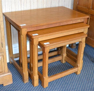 Lot 951 - A Robert  "Mouseman " Thompson Oak Nest-of-Tables, on four octagonal legs, each with carved...