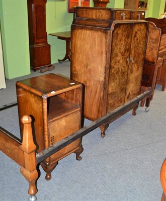 Lot 743 - A walnut bedroom suite comprising: a pair of beds, pot cupboard and cupboard