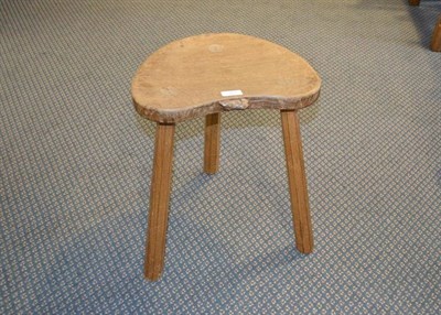 Lot 952 - A Robert  "Mouseman " Thompson Oak Cow Stool, on three tapering octagonal legs, with carved...