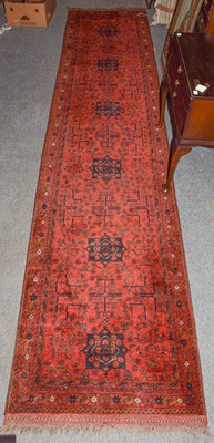 Lot 1011 - Narrow Afghan Runner, the terracotta field...