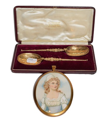 Lot 239 - A cased pair of George V silver gilt spoons,...