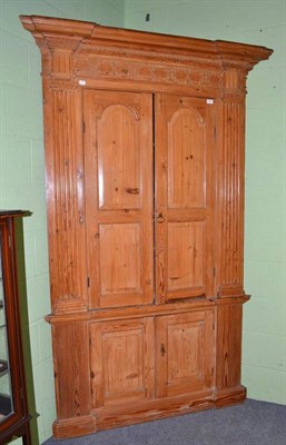 Lot 757 - A large stripped pine corner cupboard with painted interior