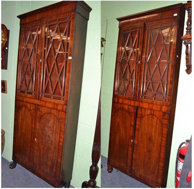 Lot 764 - A near pair of Regency mahogany bookcases with boxwood strung astragal glazed doors over two...