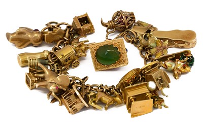 Lot 1000 - A 9 carat gold fancy link bracelet, hung with...