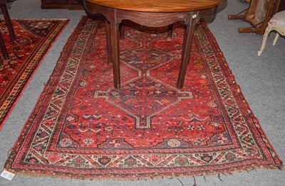 Lot 1017 - A Kashgai rug, the raspberry with geometric...