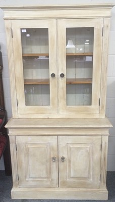 Lot 1155 - A modern cream painted bookcase cabinet of...