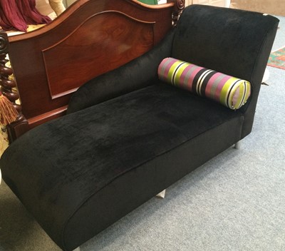 Lot 1138 - A modern black upholstered chaise-longue,...