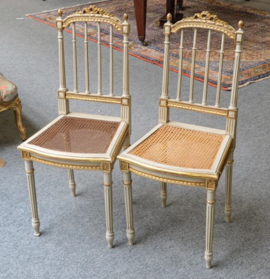 Lot 1187 - A pair of French cream painted parcel-gilt...