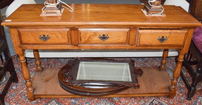 Lot 1172 - A modern oak three drawer sideboard, with pot...