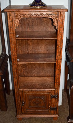 Lot 1256 - An oak carved open small bookcase, the base...