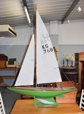 Lot 309 - A large painted pond yacht stylised as a...