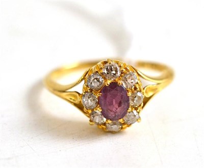 Lot 6 - A ruby and diamond cluster ring, stamped '18CT'