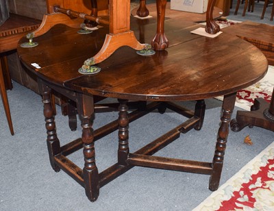 Lot 1214 - A 19th century oak gateleg dining table, 145cm...