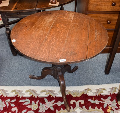 Lot 1224 - A George II provincial oak tilt top tripod...