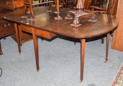 Lot 1227 - A George III mahogany drop leaf dining table,...