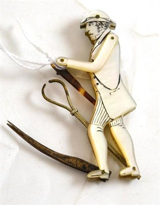 Lot 12 - A 19th century mother-of-pearl figural tool, of a gentleman, with tweezers and points