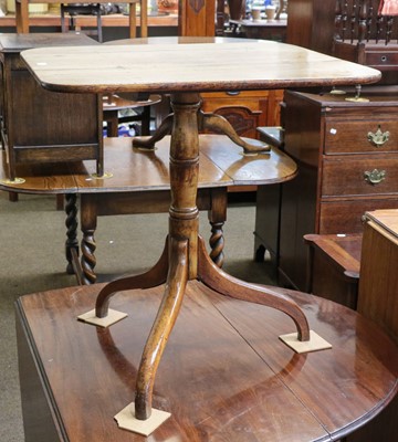 Lot 1318 - A Georgian oak snap top table raised on tripod...