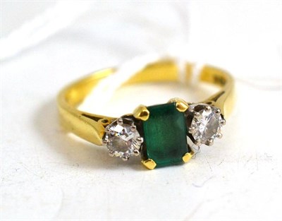 Lot 42 - An 18ct gold emerald and diamond three stone ring, estimated diamond weight 0.40 carat...