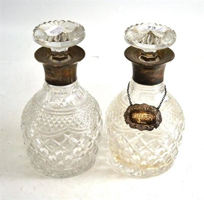 Lot 73 - Pair of decanters and stoppers with silver collars and one sherry decanter label