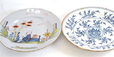 Lot 82 - An English Delft polychrome charger and a Dutch Delft charger