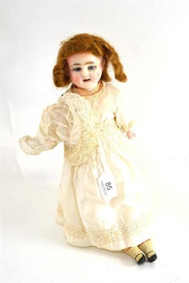 Lot 85 - A late 19th century wax shoulder head doll with blue glass eyes, in cream silk dress with bonnet