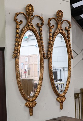 Lot 1163 - A pair of reproduction oval gilt framed wall...