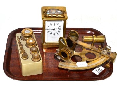 Lot 109 - A brass carriage timepiece, a set of graduated brass weights and a sextant