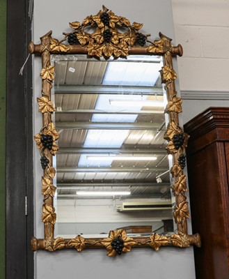 Lot 1336 - A giltwood wall mirror ornamented with...