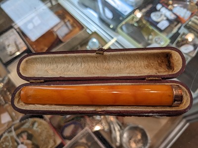 Lot 1 - An amber cigar holder with a 9 carat gold...