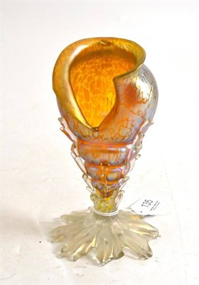 Lot 135 - A Loetz iridescent yellow glass triton shell, with splayed coral shaped foot, unmarked