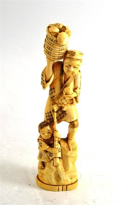 Lot 136 - A Japanese Meji period marine ivory one piece carving of a labourer and a child