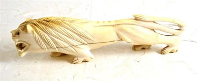 Lot 147 - An early 20th century carved ivory lion