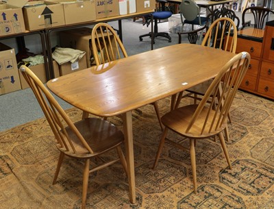 Lot 1144 - An Ercol light elm dining table and set of...