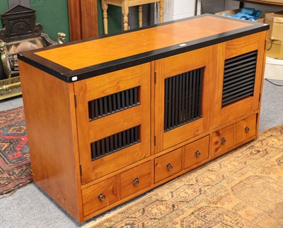 Lot 1412 - A contempory pine and part ebonised sideboard...