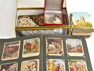 Lot 158 - A small quantity of collectables including coins, costume jewellery, postcards, an album of...