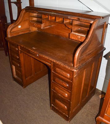 Lot 1261 - A 1920's oak roll top desk (a.f.), 120cm by...