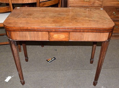 Lot 1284 - A George III mahogany fold over card table...