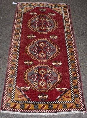 Lot 1220 - Kars rug, the claret field with three hooked...