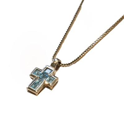 Lot 58 - An 18 carat white gold blue topaz cross...
