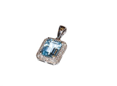 Lot 69 - A 9 carat gold blue topaz and diamond pendant,...