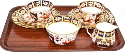 Lot 254 - Two Royal Crown Derby Imari pattern teacups, saucers, two side plates and a cream and sugar basin