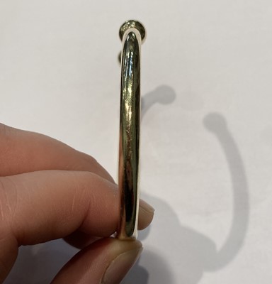 Lot 2 - A 9 carat gold torque bangle, inner...