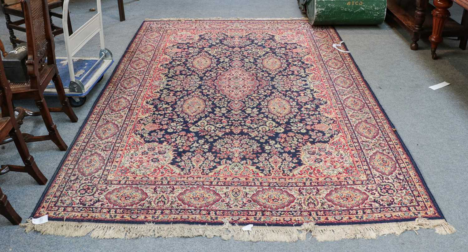 Lot 1215 - A machine made carpet of oriental design, the...