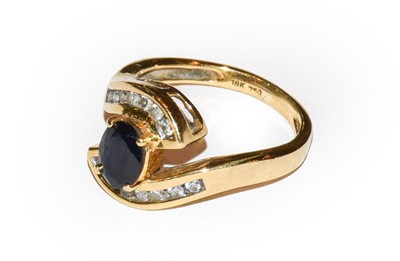 Lot 9 - A sapphire and diamond ring, stamped '18K' and...