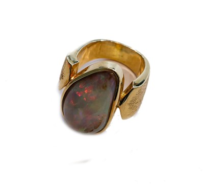 Lot 174 - An opal ring, the pear shaped cabochon opal in...