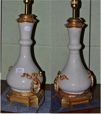 Lot 314 - A pair of crackle glazed table lamps with gilt metal mounts