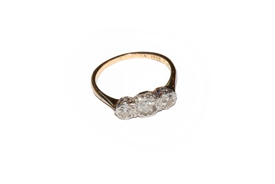 Lot 49 - A diamond three stone ring, stamped '18CT' and...