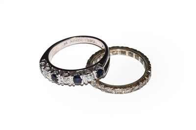 Lot 19 - A sapphire and diamond half hoop ring, stamped...
