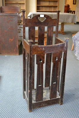 Lot 994 - An Arts & Crafts Oak Stick Stand, retailed by Liberty & Co, the back with heart aperture...