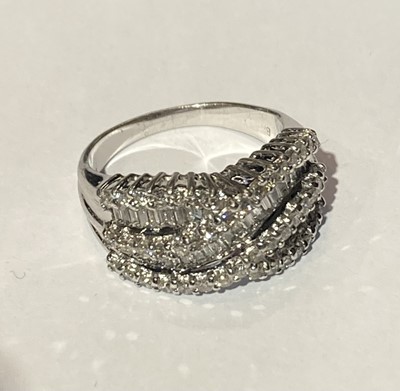 Lot 81 - A diamond two row twist ring, stamped '14K',...